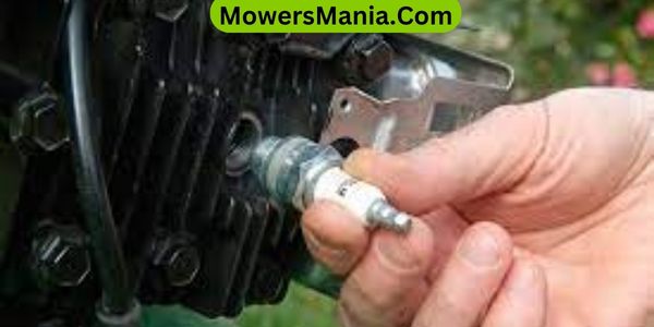 Where is spark plug on lawn mower